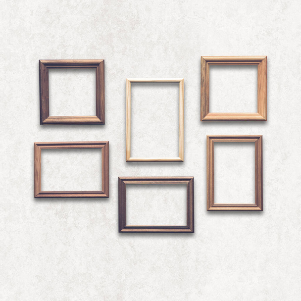 wooden photo frames on white wall - Photo, image