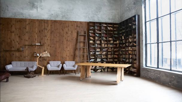 інтер'єр сучасної фотостудії з книжковою шафою і м'якими меблями
 - Фото, зображення