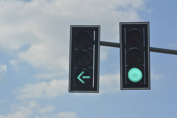 Green color on the traffic light with blue sky in background  - Fotó, kép