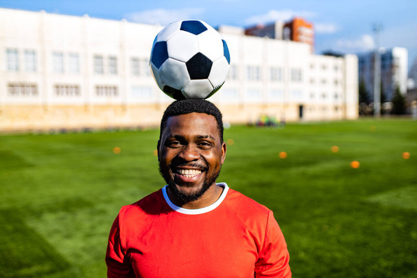 happy multicultural hispanic soccer player smiling and wear red sporty suit outdoor sunny day - Valokuva, kuva