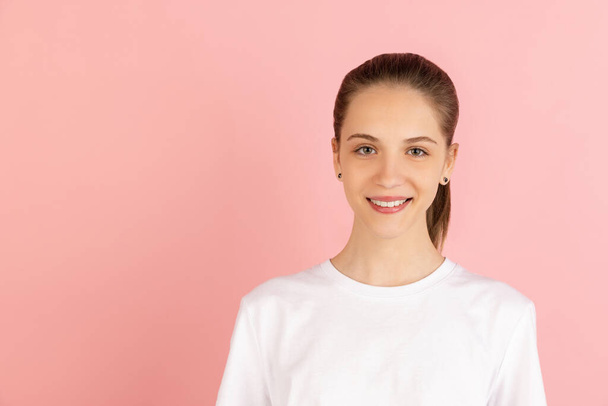 Caucasian young womans portrait isolated over pink studio background with copyspace - Foto, Imagen