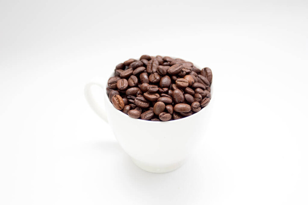 Coffee beans in white cup on white background. - Photo, Image
