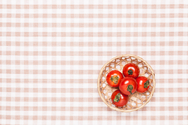 tomatoes on the table and put it in a basket - Photo, Image
