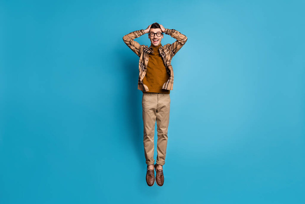 Full size photo of young happy excited amazed shocked man jumping on black friday isolated on blue color background - Фото, изображение