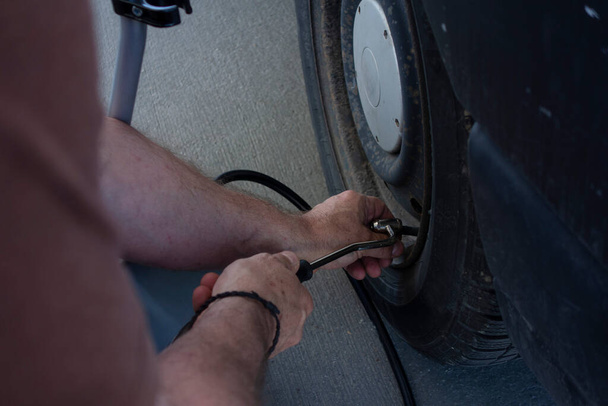 checking the tire inflation pressure of a car and inflate tire with air - Photo, Image