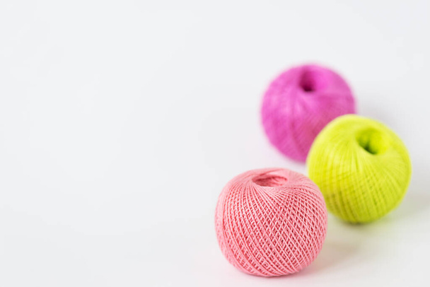 Multicolored threads for knitting on a white background. Horizontal orientation, copy space. - 写真・画像