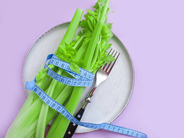 fresh celery measuring tape on white background - Photo, Image