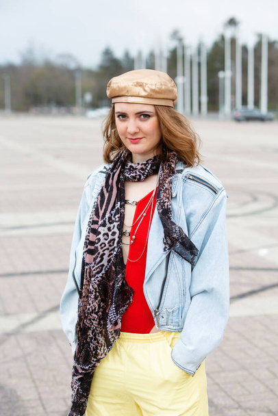 portrait of a young brunette woman in 1980s style outside on street - Photo, image