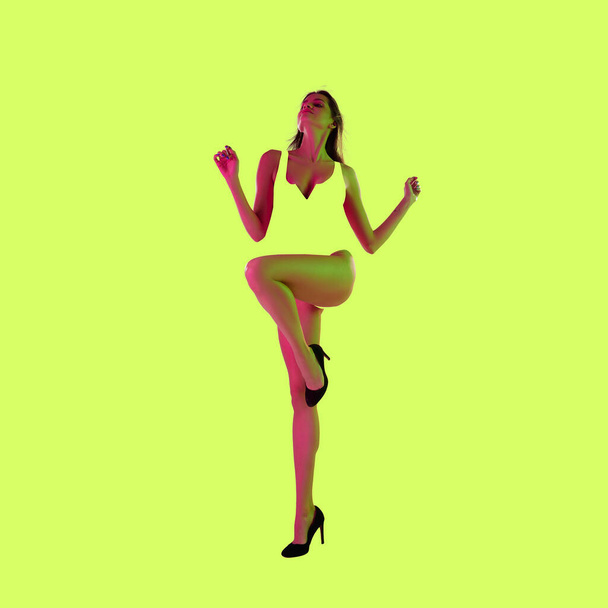 Modern design, contemporary art collage. Inspiration, idea, trendy magazine style. Sport. Beautiful woman with fit body on yellow background. - Valokuva, kuva