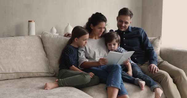 Happy family with kids enjoy interesting fairytale book - Кадри, відео