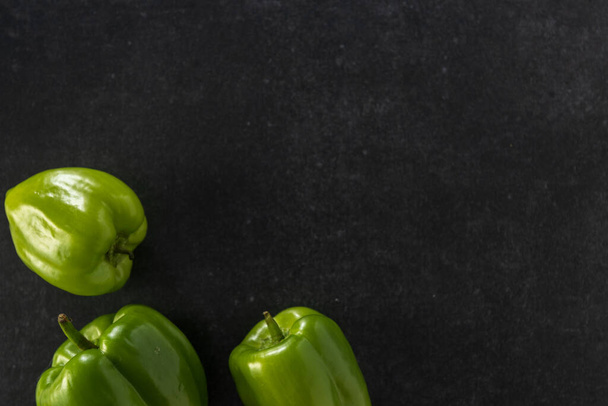 bright fresh green bell pepper on gray background, top view, empty space for text - Foto, Imagen