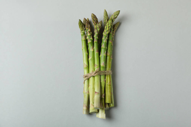 Bunch of fresh asparagus on light gray background - Photo, image