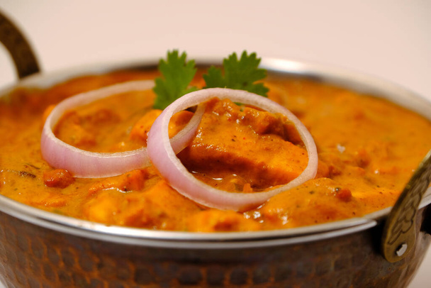Paneer Butter Masala or Cheese Cottage Curry, popular Indian Lunch/Dinner menu served in copper brass bowl - Photo, Image