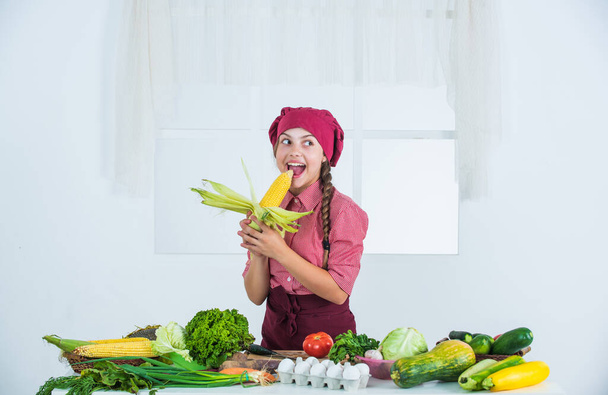 cheerful child girl cooking vitamin salad from vegetables, natural - Foto, Imagem