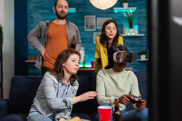 Multi ethnic friends socialising playing video games - Foto, Imagem