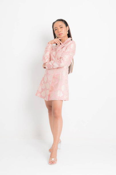 Mode-Stil Katalog Kleidung für Geschäftsfrau schwarz lange Haare natürliches Make-up tragen rosa Kleid Kostüm perfekte Körperform Anzug bei Studio-Shooting auf weißem Hintergrund und Schatten. - Foto, Bild