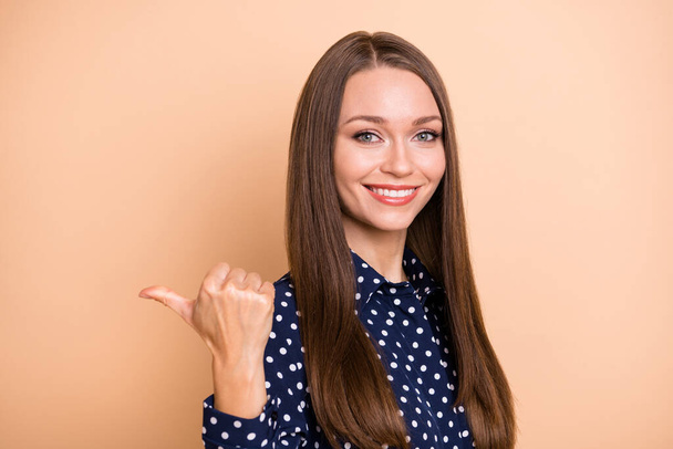 Profile side photo of young woman happy smile indicate thumb empty space ad promo select suggest isolated over beige color background - Фото, зображення