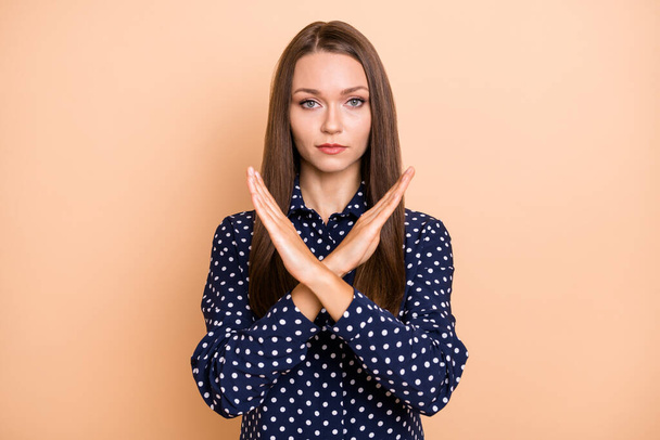 Photo of young woman unhappy crossed hands show no stop ban block denial sign isolated over beige color background - Fotografie, Obrázek