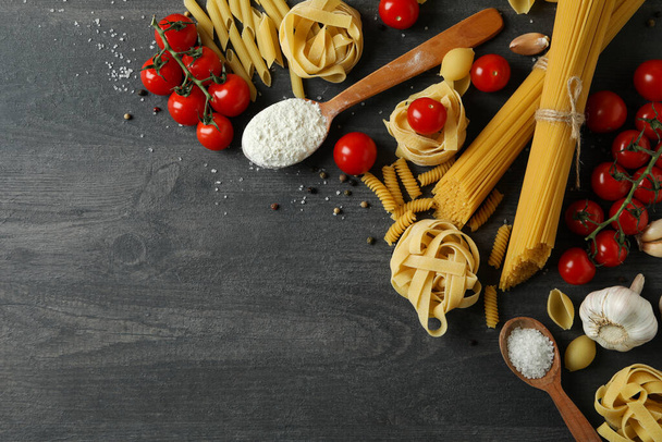 Concept of cooking tasty pasta on dark wooden background - Photo, Image