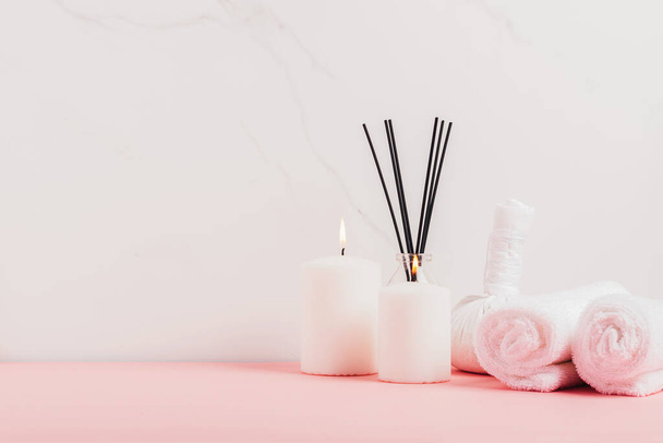 Incense sticks candles towelmassage herbal bags white marble background. Massage, oriental therapy, alternative medicine - Photo, Image