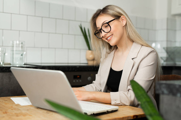 beautiful young woman working at home with laptop - Φωτογραφία, εικόνα
