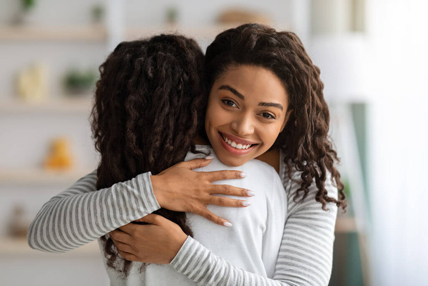 Positivo nero madre abbraccio suo figlia, primo piano - Foto, immagini
