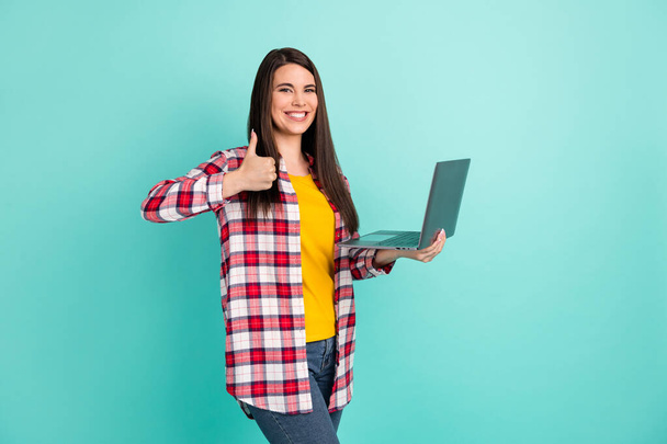 Photo of joyful happy young lady make thumb-up recommend quality hold laptop isolated on teal color background - Fotoğraf, Görsel