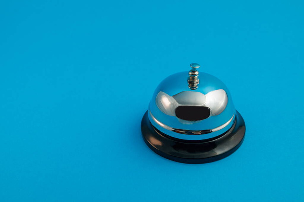 chrome bell for reception on a blue background - Foto, Bild