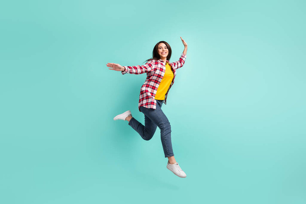 Full size profile side photo of charming young woman jump up walk empty space isolated on teal color background - Фото, изображение