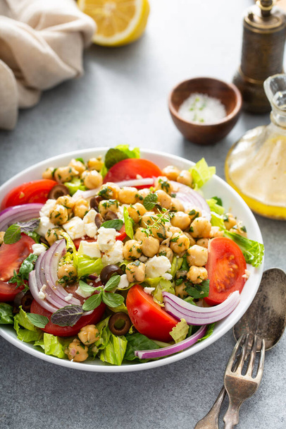 Healthy spring Greek salad with fresh vegetables and chickpeas - Photo, image