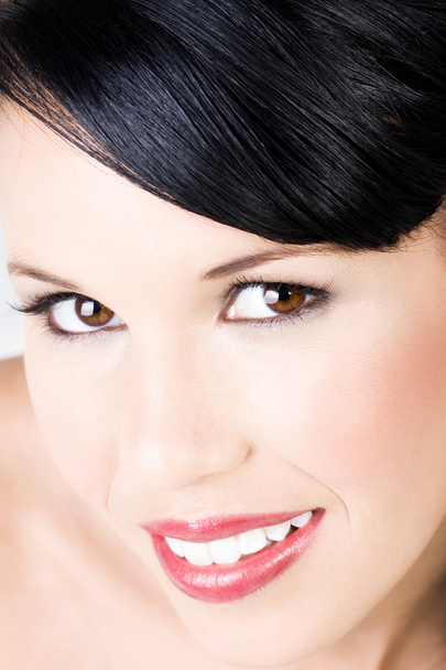 Young beautiful female wearing makeup with gentle smile - Фото, зображення