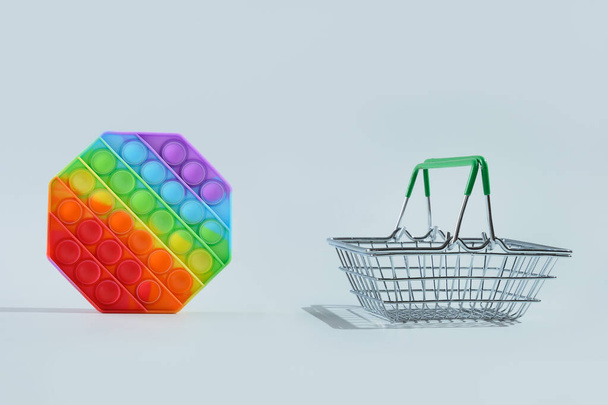 New popular silicone colorful antistress pop it toy and shopping basket. - Photo, Image