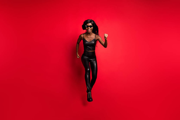 Full length body size view of cheery motivated girl wear leather suit jumping running fast speed friday isolated on bright red color background - Φωτογραφία, εικόνα