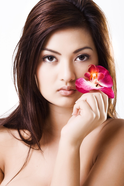 Young beautiful asian model with purple orchid - Φωτογραφία, εικόνα