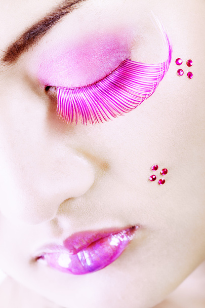 Detail of a face with colorful makeup and eyelashes - Foto, imagen