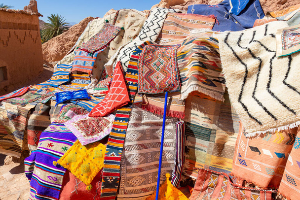 Tapis et couvre-lits colorés à vendre aux touristes près de l'ancienne Kasbah Ait Benhaddou près de Ouarzazate, Maroc - Photo, image
