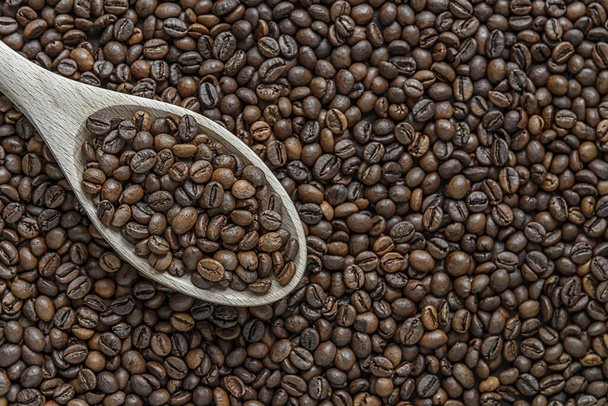 rozmanitá kávová zrna a dřevěná lžíce - Fotografie, Obrázek
