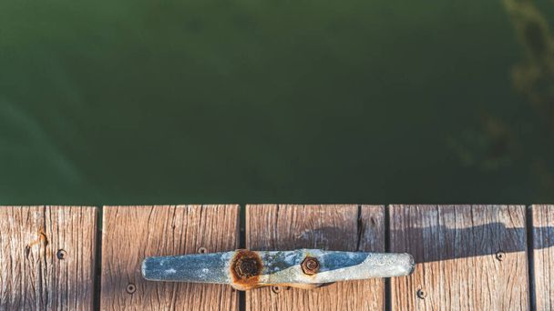 Overhead shot of Rusting mooring cleat on dock with copy space  - Photo, Image