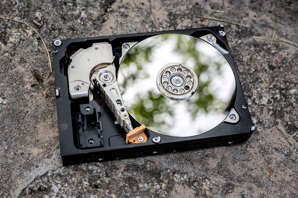 View on a hard disk drive on a concrete surface on a sunny day. - Photo, Image