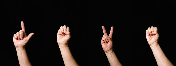 Palabra Amor hecho con la mano gestos lenguaje de señas internacionales sobre fondo negro - Foto, imagen