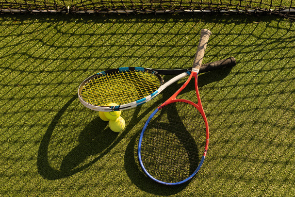 A tennis racket and new tennis ball on a freshly painted tennis court - Photo, Image