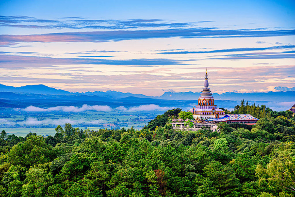 Beautiful pagoda of Tha Ton Temple set amid green mountains in Chiang Mai,Thailand. Place for religious practices northern of Thailand - Photo, Image