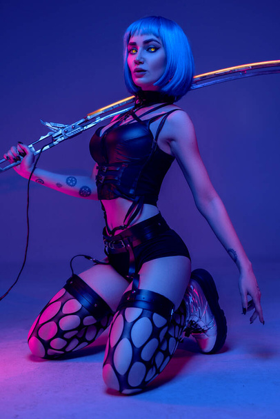 Evil cyberpunk woman with glaring eyes and sword - Fotó, kép