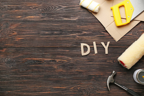 Set of tools and word DIY on wooden background - Foto, Imagen