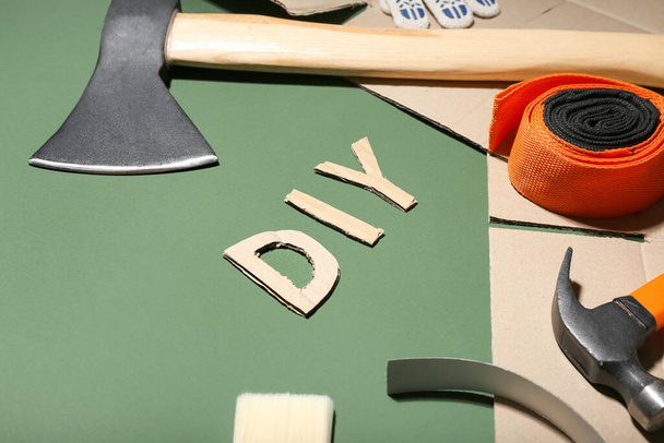 Set of tools and word DIY on color background, closeup - Photo, Image