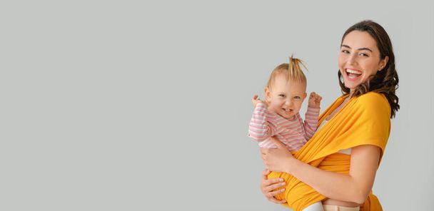 Happy woman and her little daughter on light background - Foto, Imagem