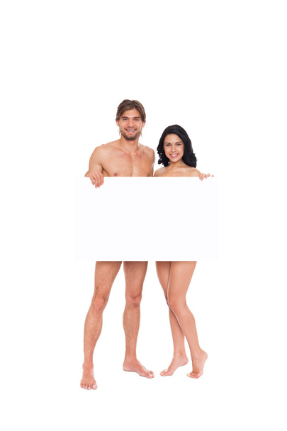 Couple in swimsuits showing blank board - Fotoğraf, Görsel