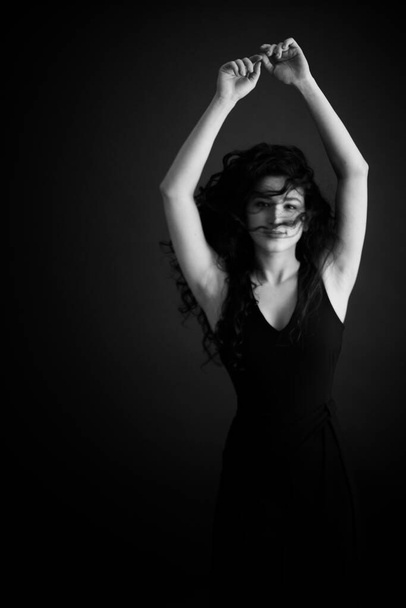 Fashion portrait of a dancer in a black classic dress. - Foto, Imagem