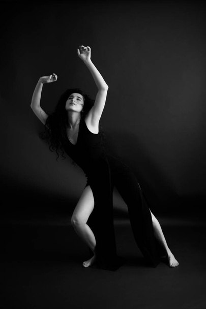 Fashion portrait of a dancer in a black classic dress. - Photo, Image
