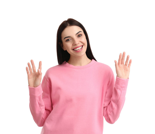 Attractive young woman showing hello gesture on white background - Photo, image
